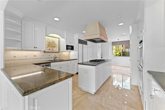 a view of a kitchen with a sink and a chandelier