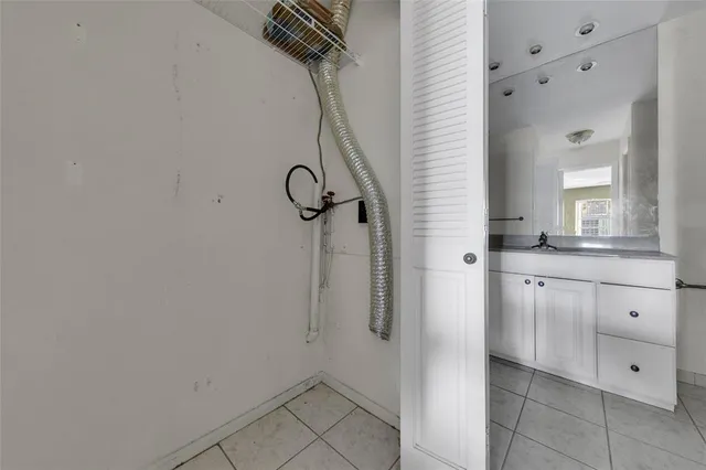 a spacious bathroom with a mirror and a sink