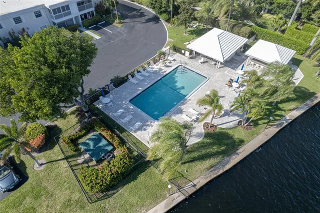 a view of swimming pool with outdoor seating and plants