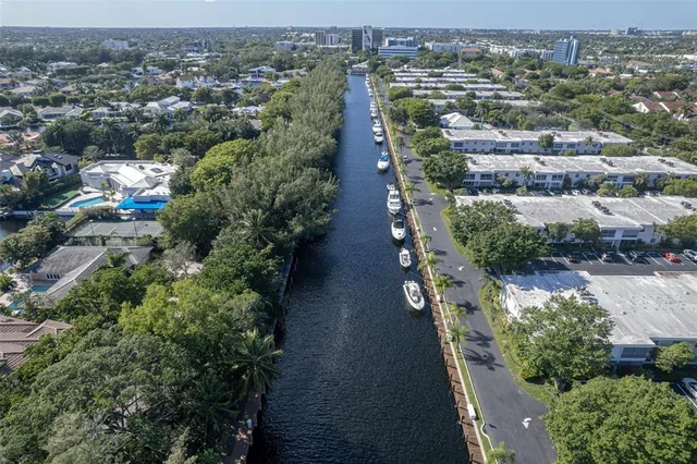 a patio with table and chairs and potted plants