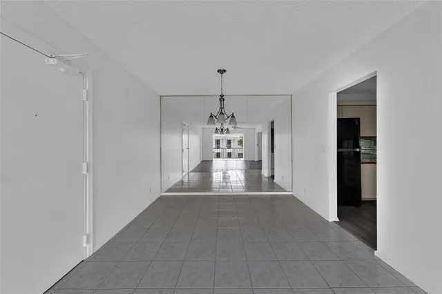 a view of a livingroom with wooden floor and a ceiling fan