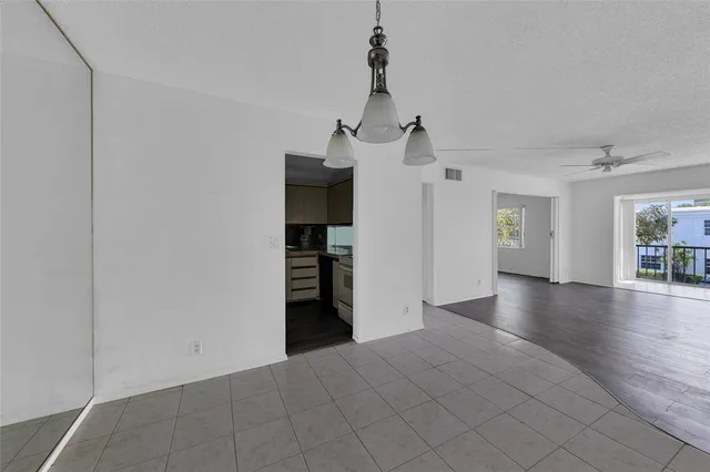 a kitchen with granite countertop a sink stove and cabinets
