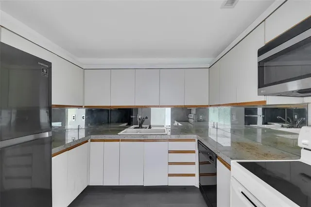 a kitchen with a stove microwave and sink