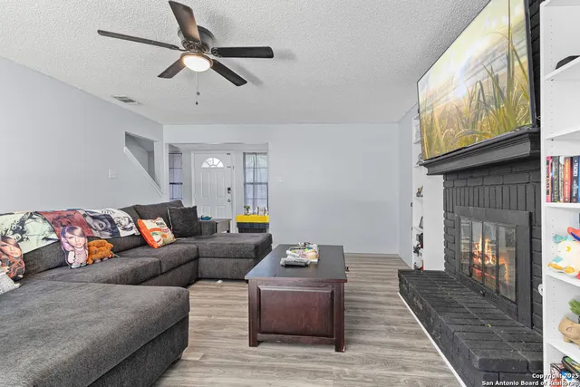 a living room with furniture and a fireplace