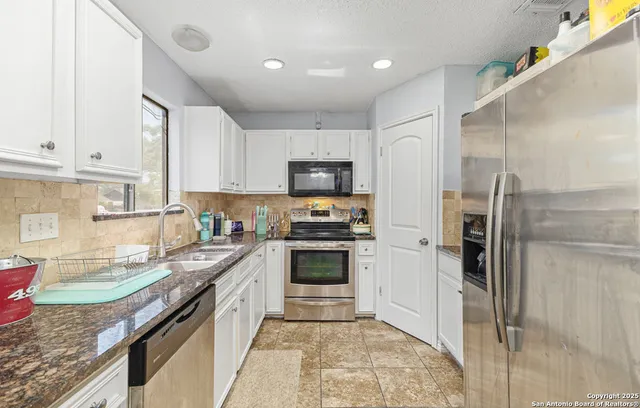 a kitchen with a sink stove and refrigerator
