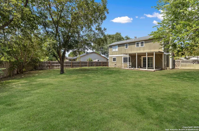 a view of a house with a backyard
