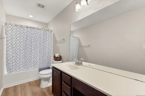 a bathroom with a sink toilet and a mirror