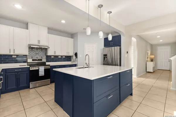 a kitchen with a sink a stove and cabinets