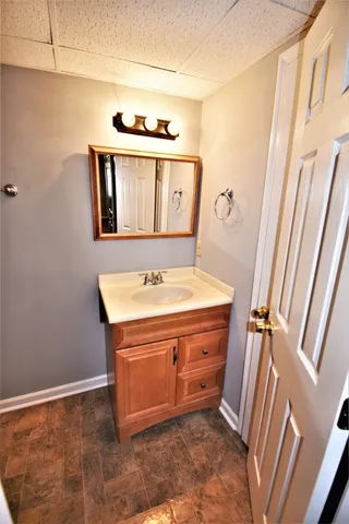 a bathroom with a sink a mirror and shower