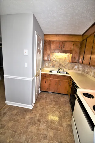 a view of a kitchen with a sink and dishwasher