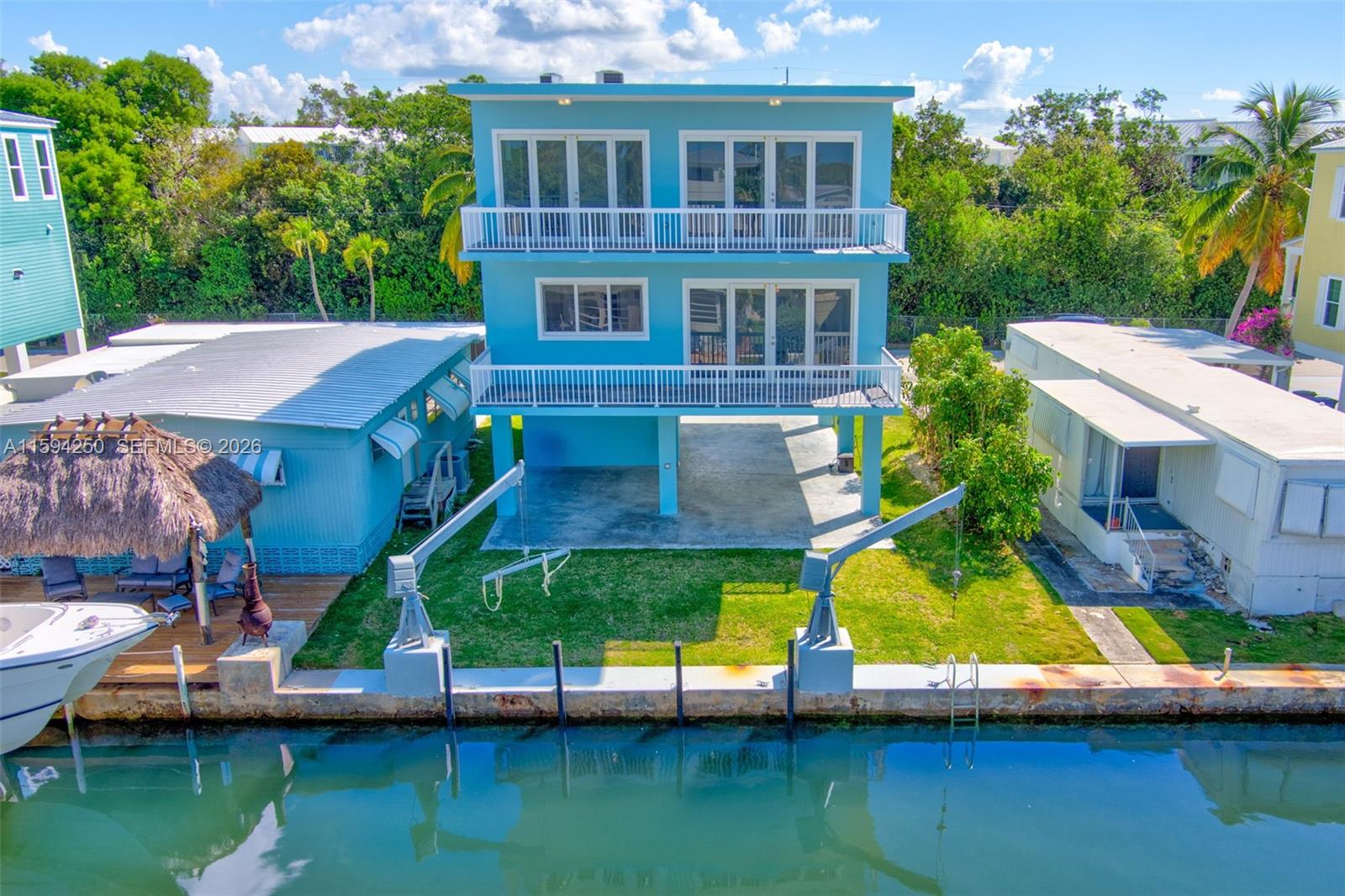 84 Coral Way Key Largo, FL 33037 - Photo 2 of 55 an aerial view of a house with a yard and a fountain