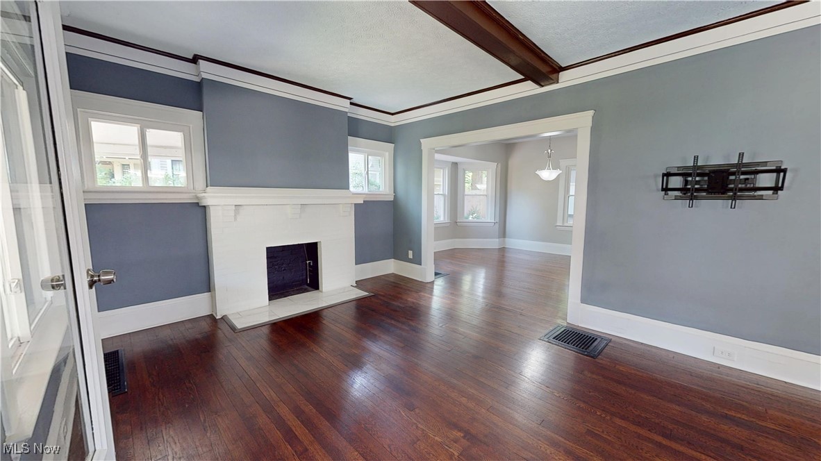 3174 Oak Road Cleveland, OH 44118 - Photo 3 of 33 Unfurnished living room with hardwood / wood-style floors, beamed ceiling, a fireplace, and ornamental molding