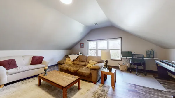 a living room with furniture or couch and a wooden floor