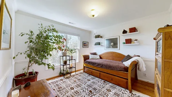 a bedroom with furniture and a potted plant