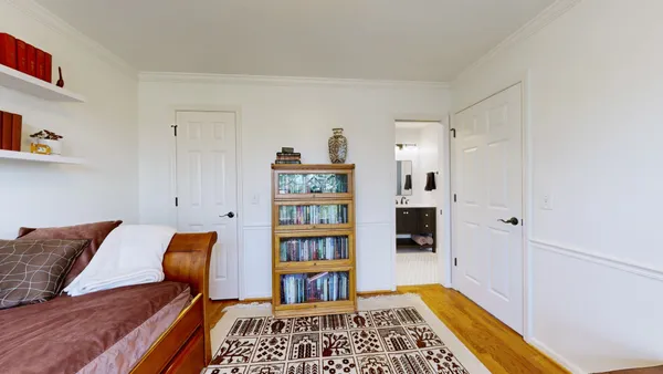 a bedroom with furniture and a book shelf