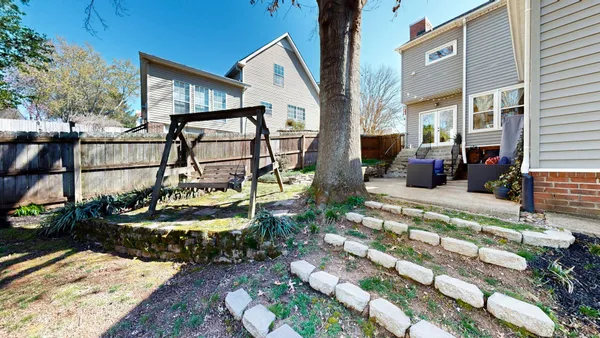 a view of a patio with couches chairs and wooden floor