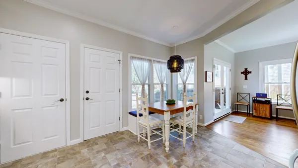 a dining room with furniture and wooden floor