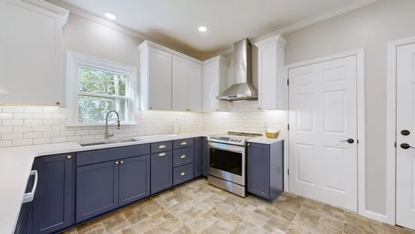 a kitchen with stainless steel appliances granite countertop a sink a stove a refrigerator and cabinets