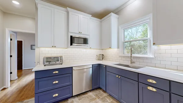 a kitchen with a sink window and cabinets