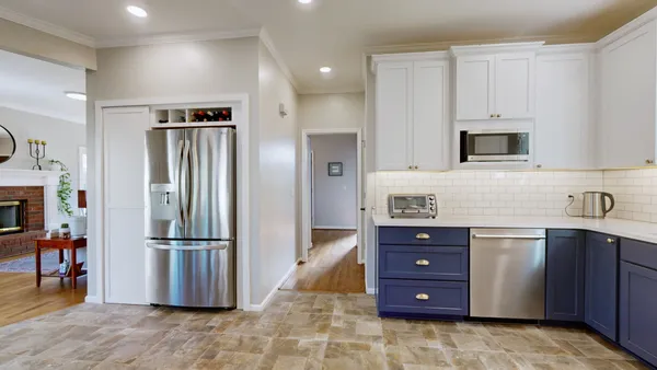 a kitchen with a refrigerator and a sink