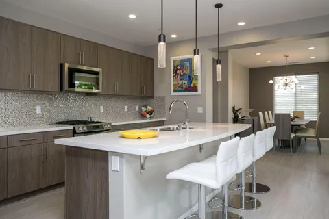 a large kitchen with a table and chairs in it