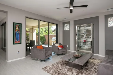a living room with furniture and floor to ceiling windows
