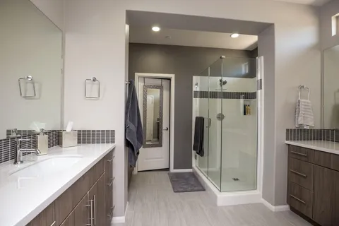 a bathroom with a shower sink and mirror