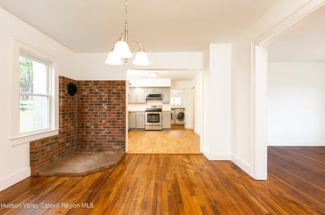 a view of a living room with wooden floor