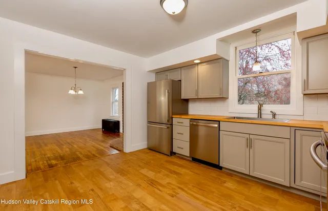 a kitchen with a sink cabinets and refrigerator