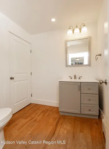 a bathroom with a sink a toilet and mirror
