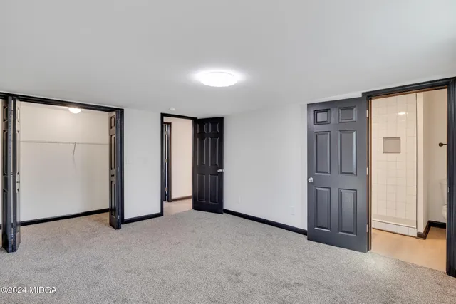 an empty room with closet area