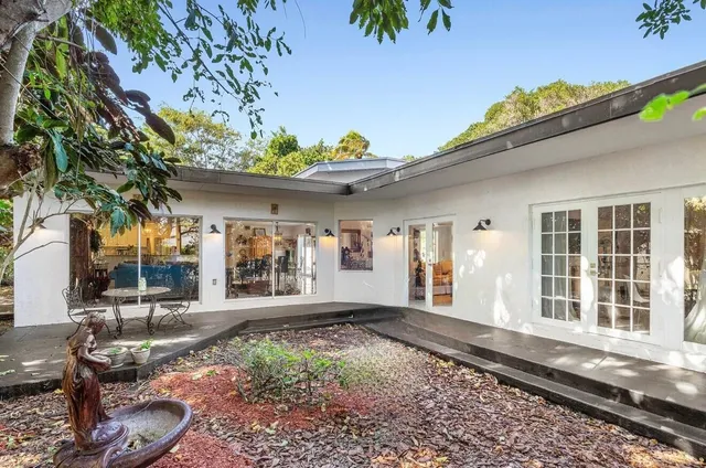 a living room with furniture a window and a dining table