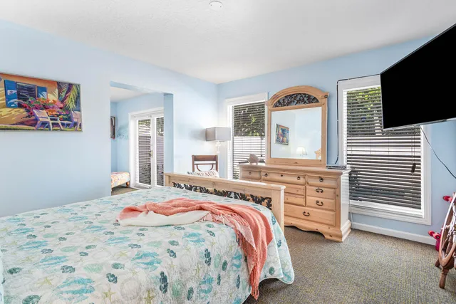 a swimming pool with outdoor seating and yard in the back