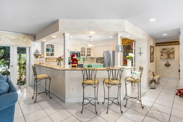 a bedroom with a bed a flat screen tv and dresser