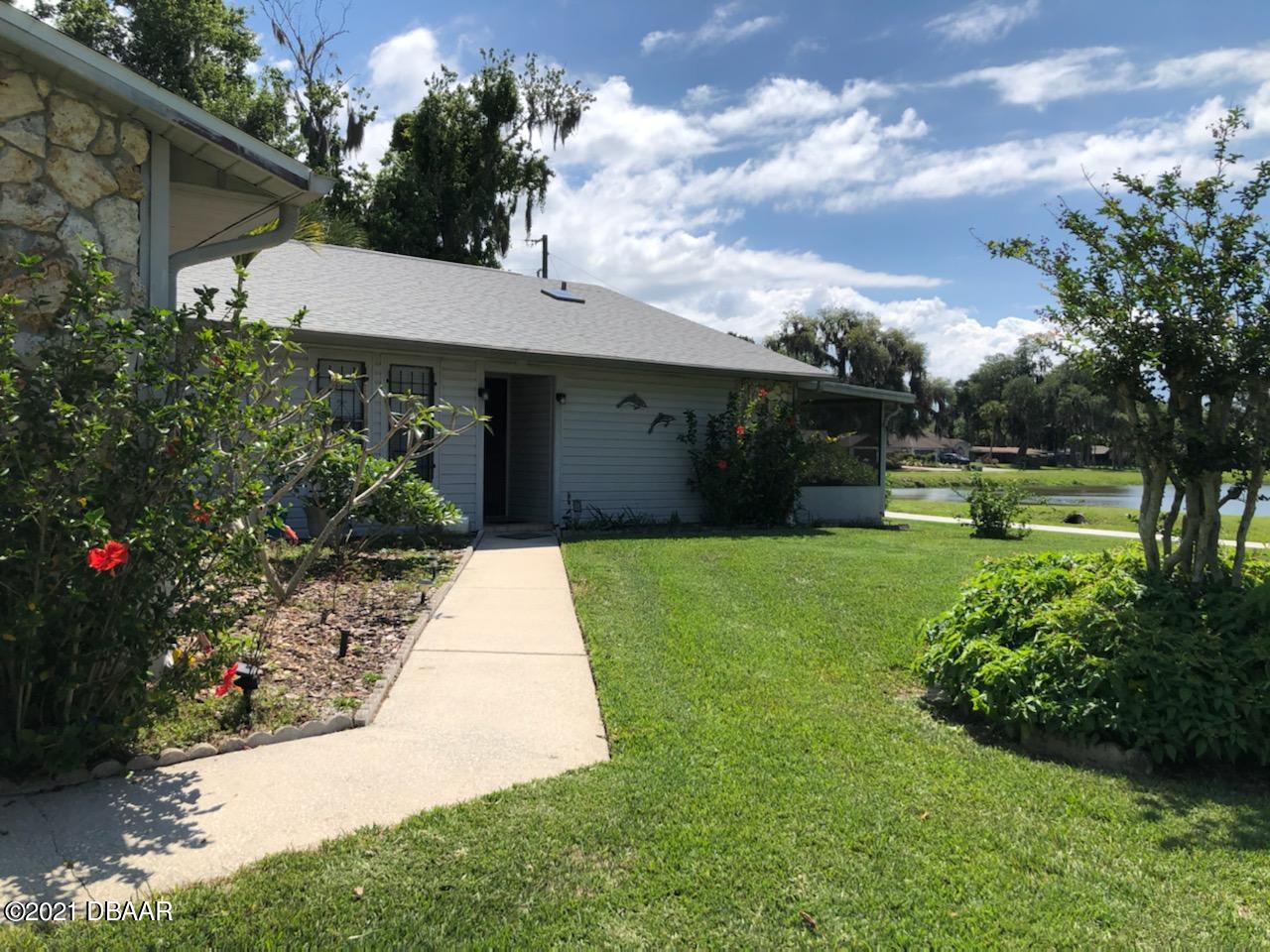 2629 Mango Tree Drive Edgewater, FL 32141 - Photo 1 of 30 a view of a house with a garden and pathway