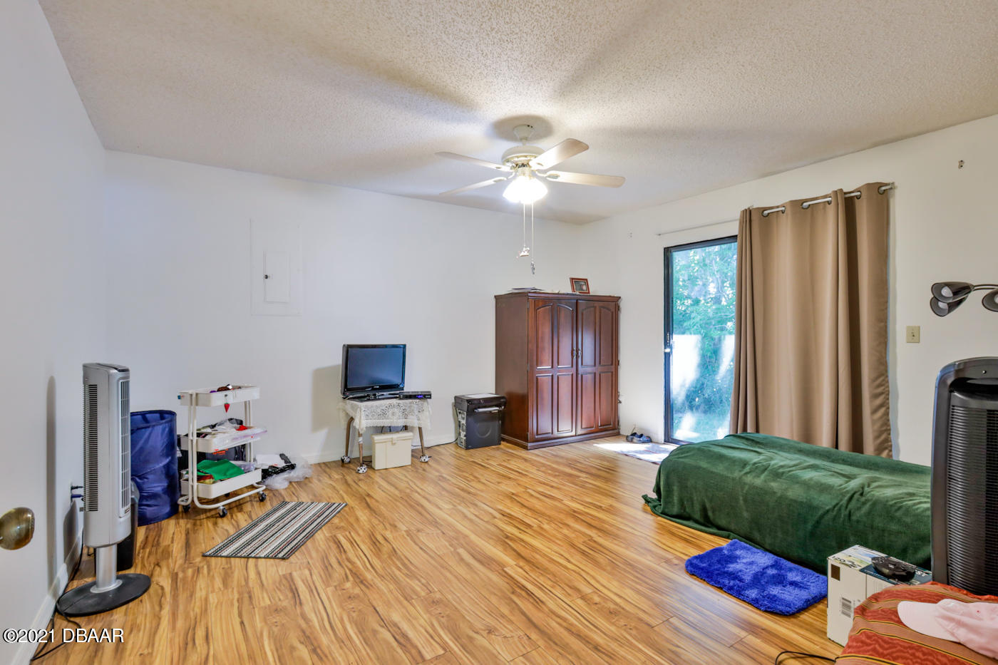2629 Mango Tree Drive Edgewater, FL 32141 - Photo 12 of 30 a bedroom with a bed and a chandelier