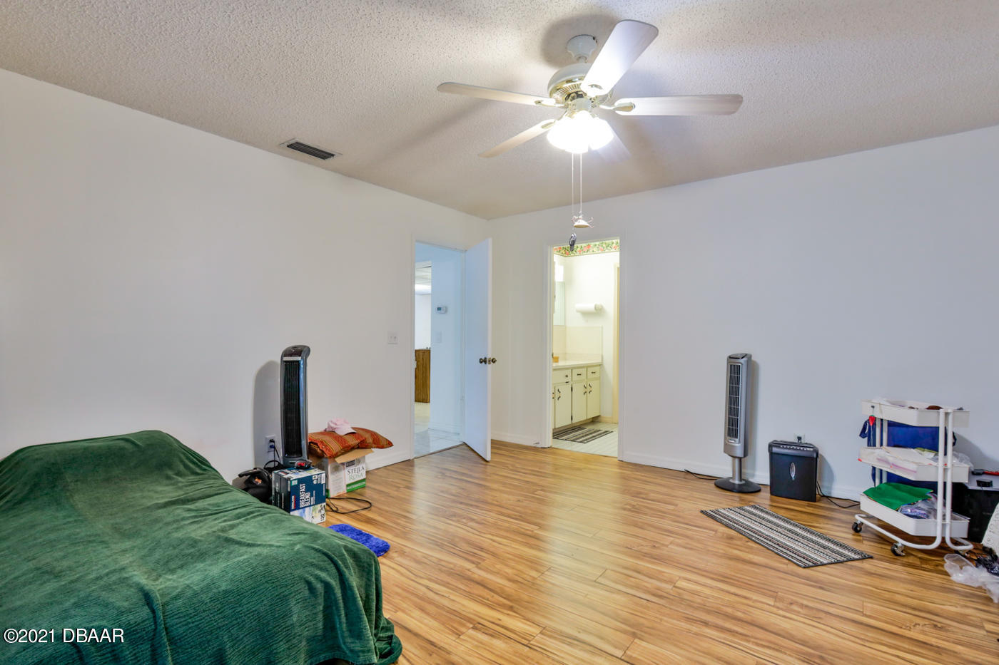 2629 Mango Tree Drive Edgewater, FL 32141 - Photo 13 of 30 a bed room with a bed dresser and a chandelier