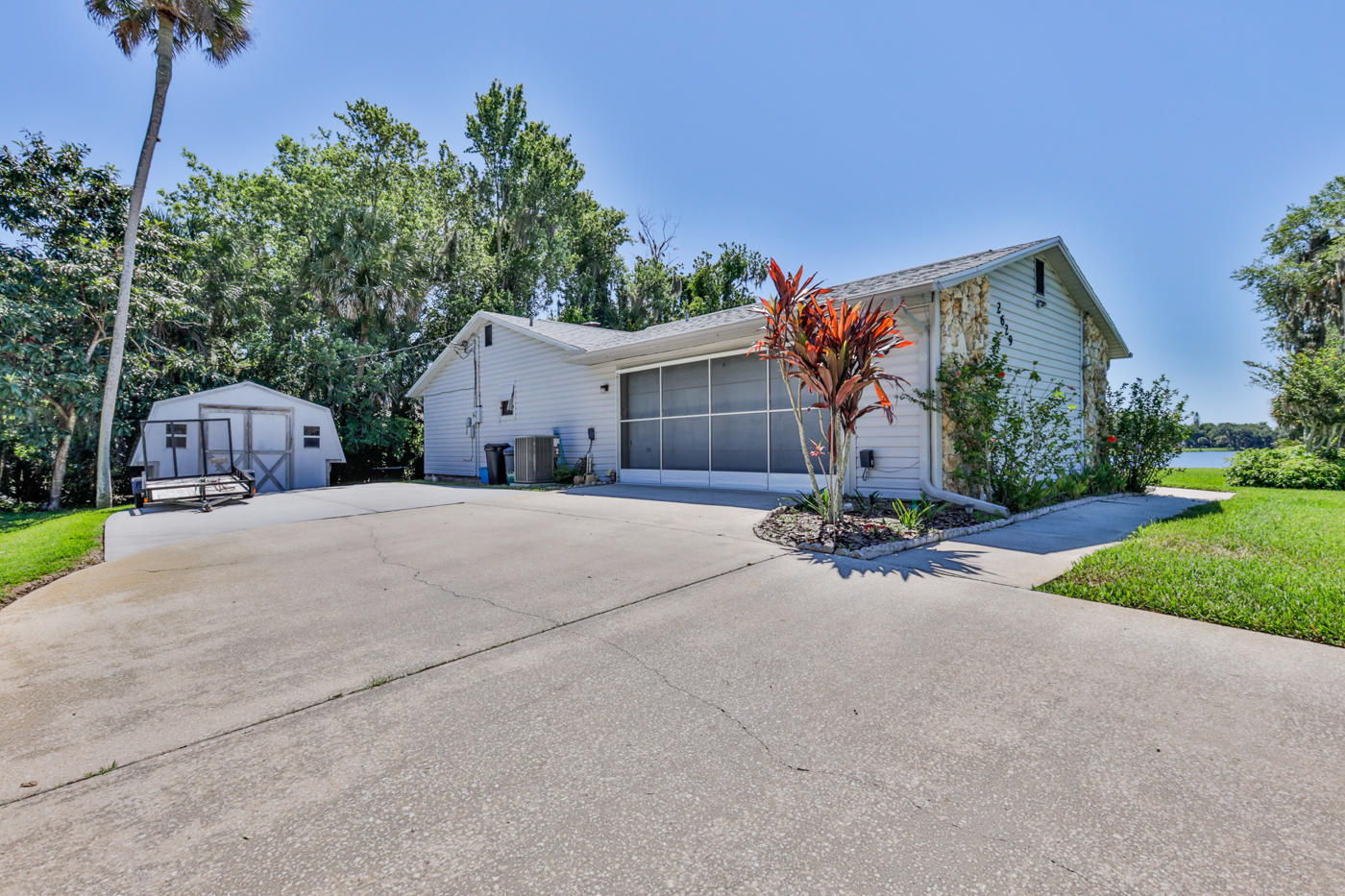 2629 Mango Tree Drive Edgewater, FL 32141 - Photo 23 of 30 a front view of a house with a yard and a garage