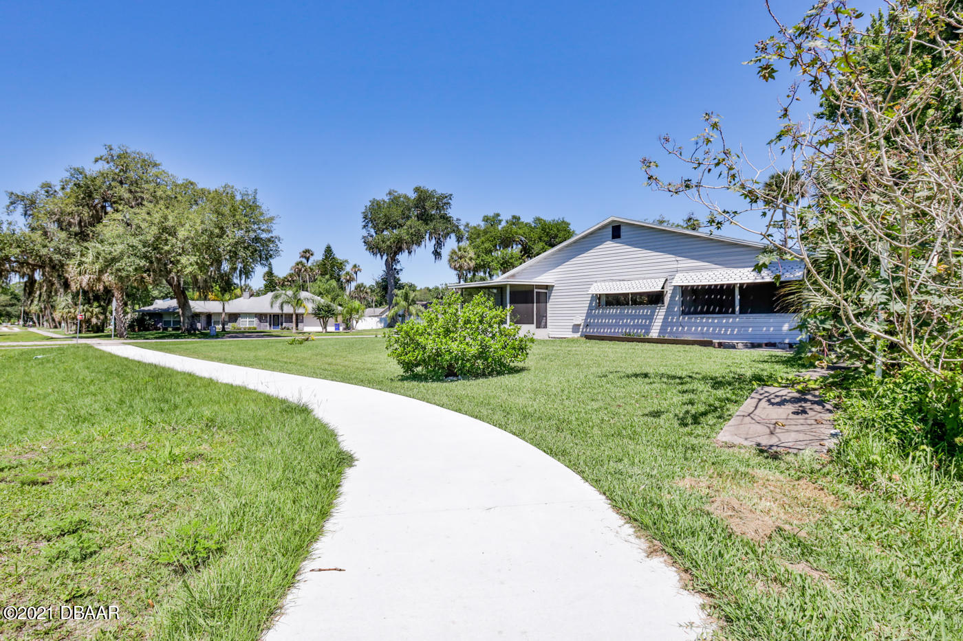 2629 Mango Tree Drive Edgewater, FL 32141 - Photo 26 of 30 a front view of a house with a yard