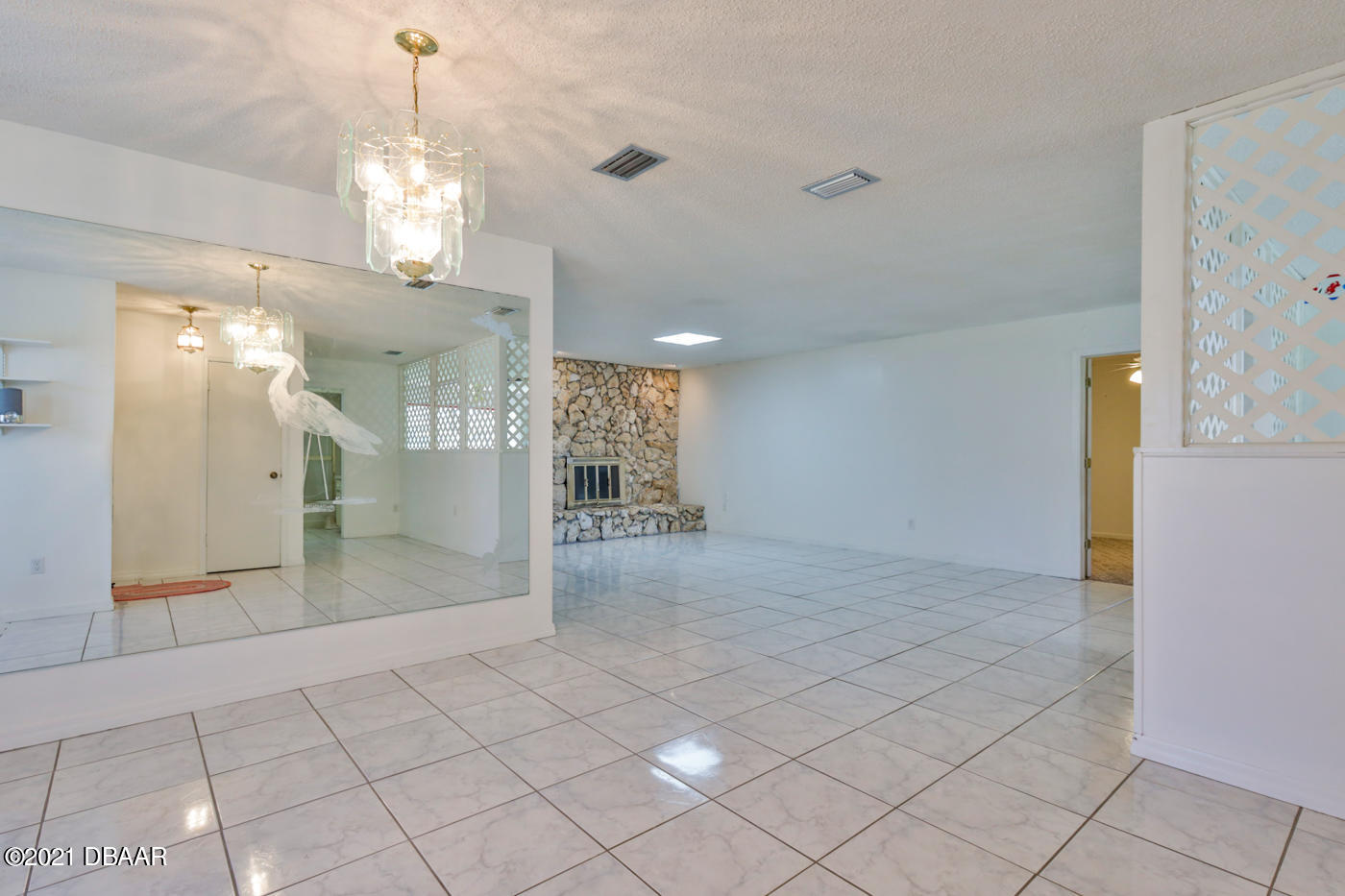 2629 Mango Tree Drive Edgewater, FL 32141 - Photo 4 of 30 a view of a hallway with granite countertop a couch and a chandelier