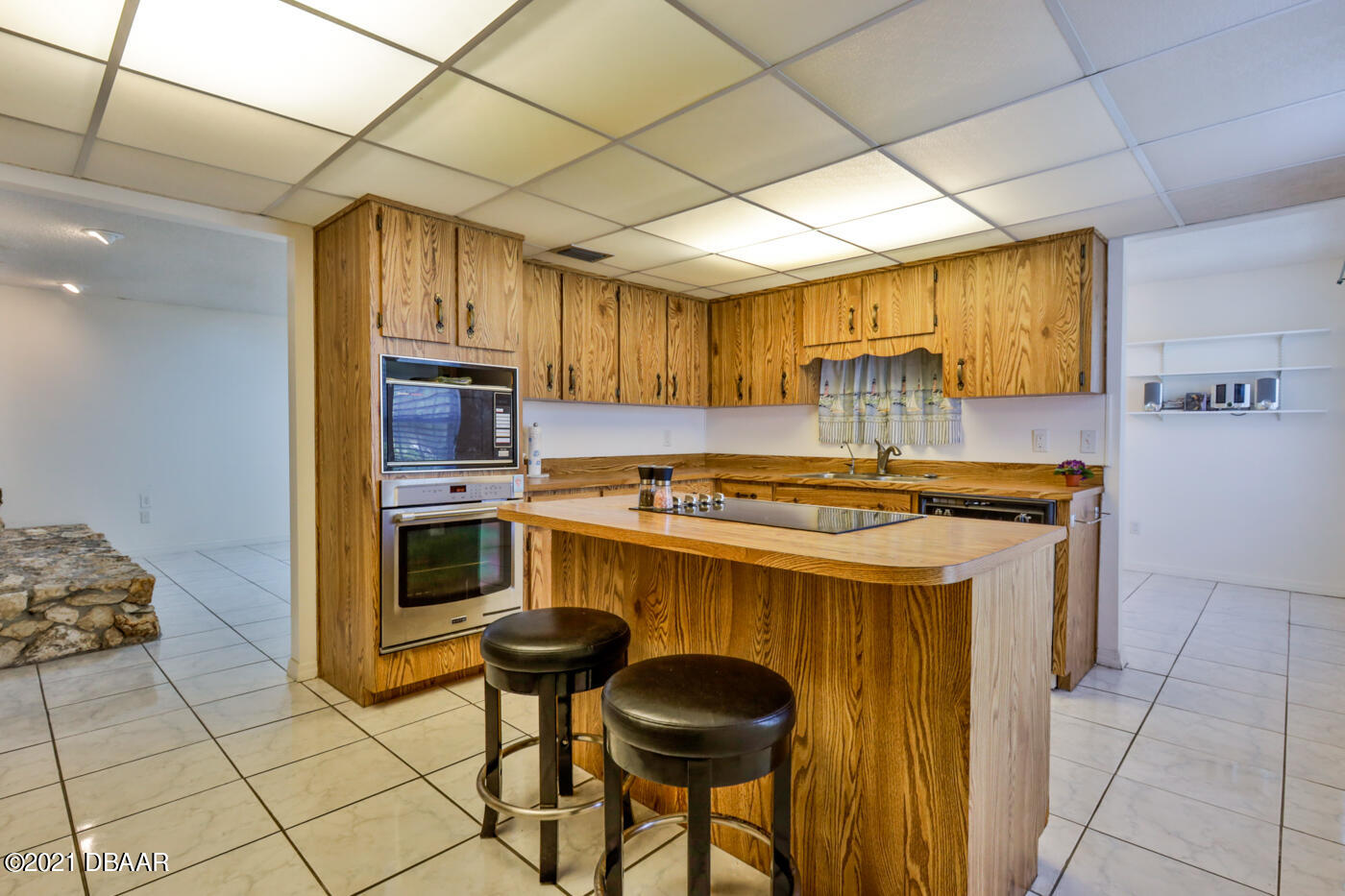2629 Mango Tree Drive Edgewater, FL 32141 - Photo 10 of 30 a kitchen with a stove a sink and a refrigerator