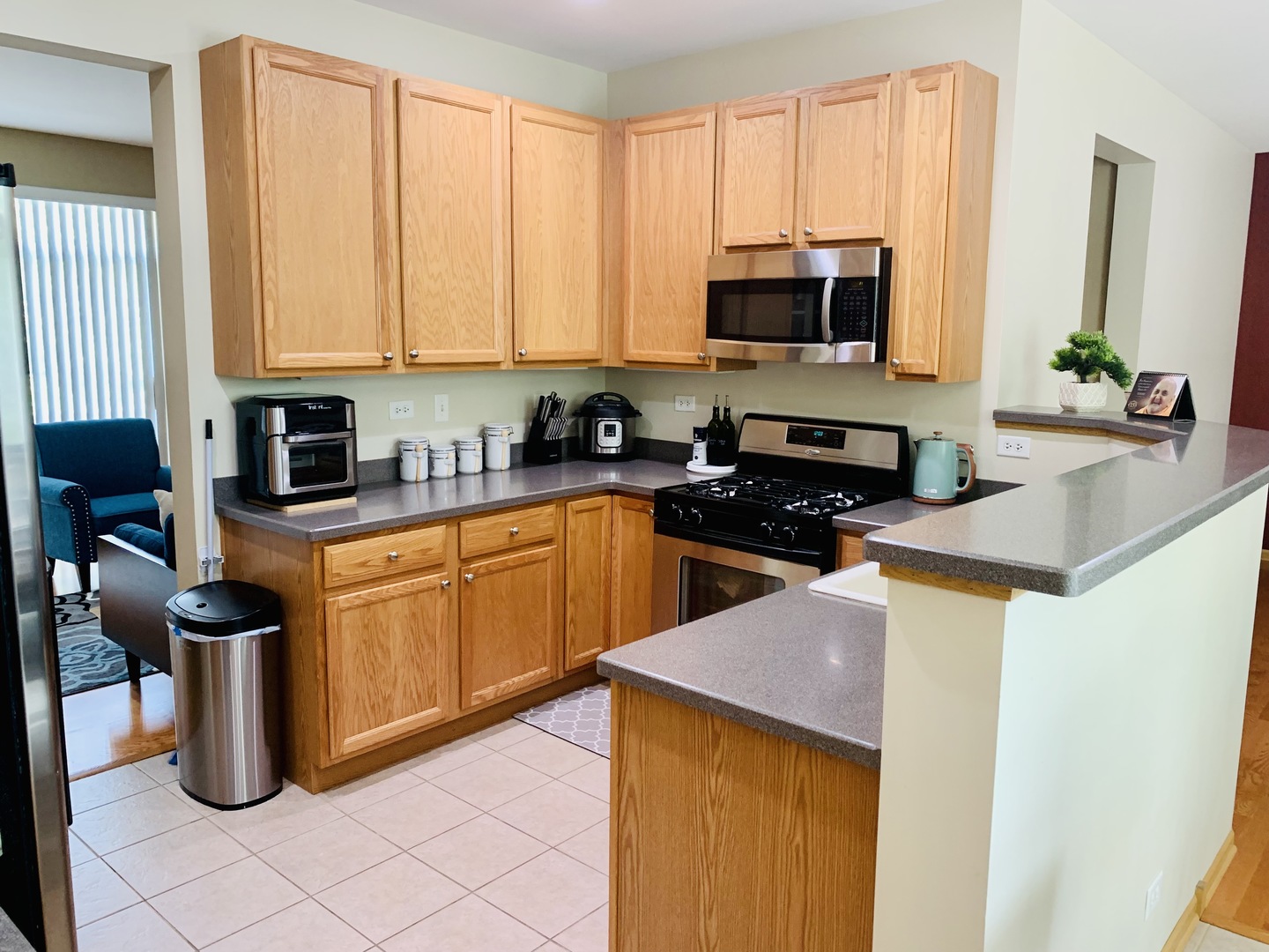 146 Goldenhill Street Carol Stream, IL 60188 - Photo 4 of 18 a kitchen with stainless steel appliances granite countertop a stove a sink and a microwave