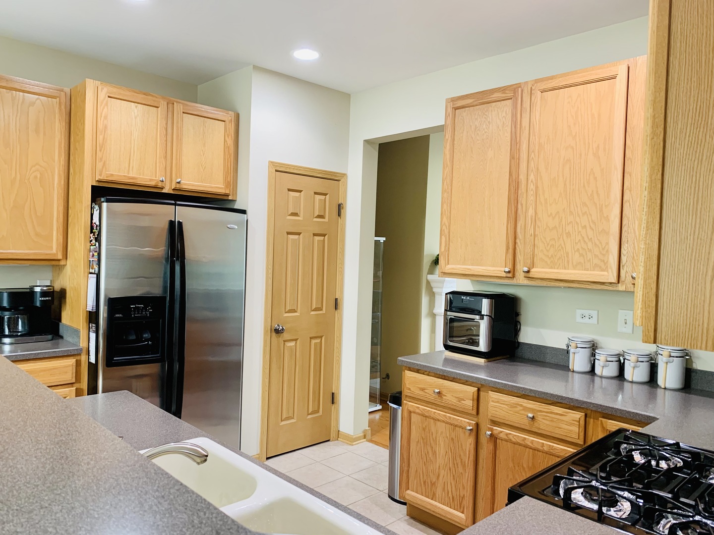 146 Goldenhill Street Carol Stream, IL 60188 - Photo 6 of 18 a kitchen with stainless steel appliances granite countertop a refrigerator and a stove top oven