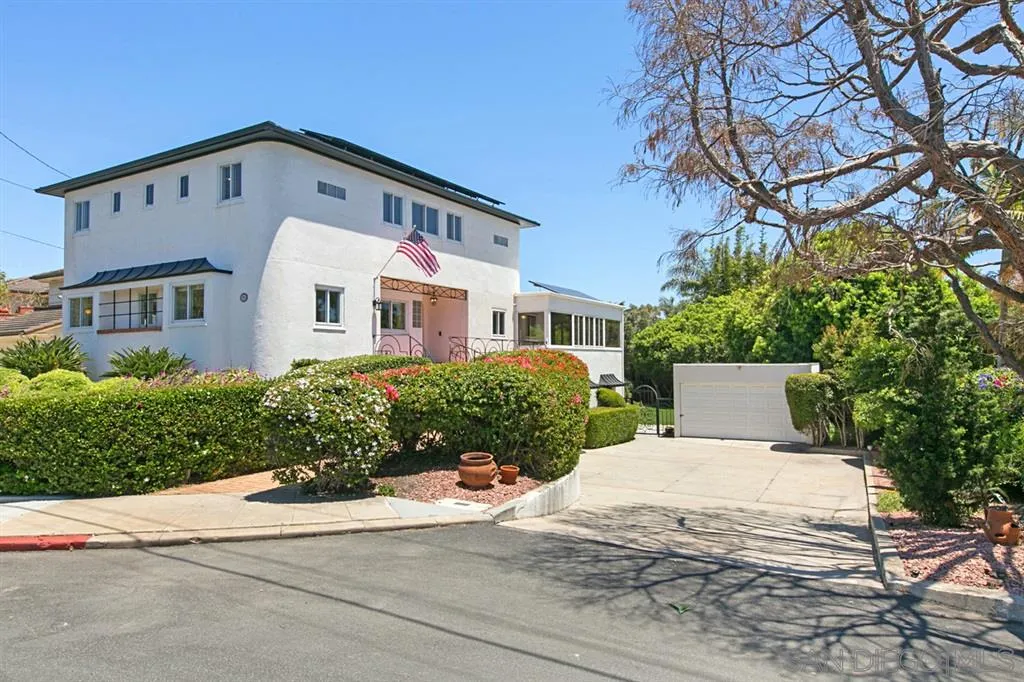 a front view of a building with a yard