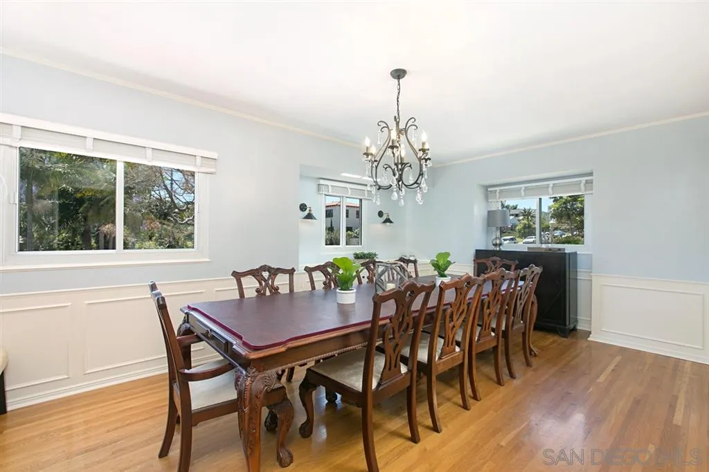 2355 Willow Street San Diego, CA 92106 - Photo 12 of 25 a view of a dining room with furniture a chandelier and wooden floor