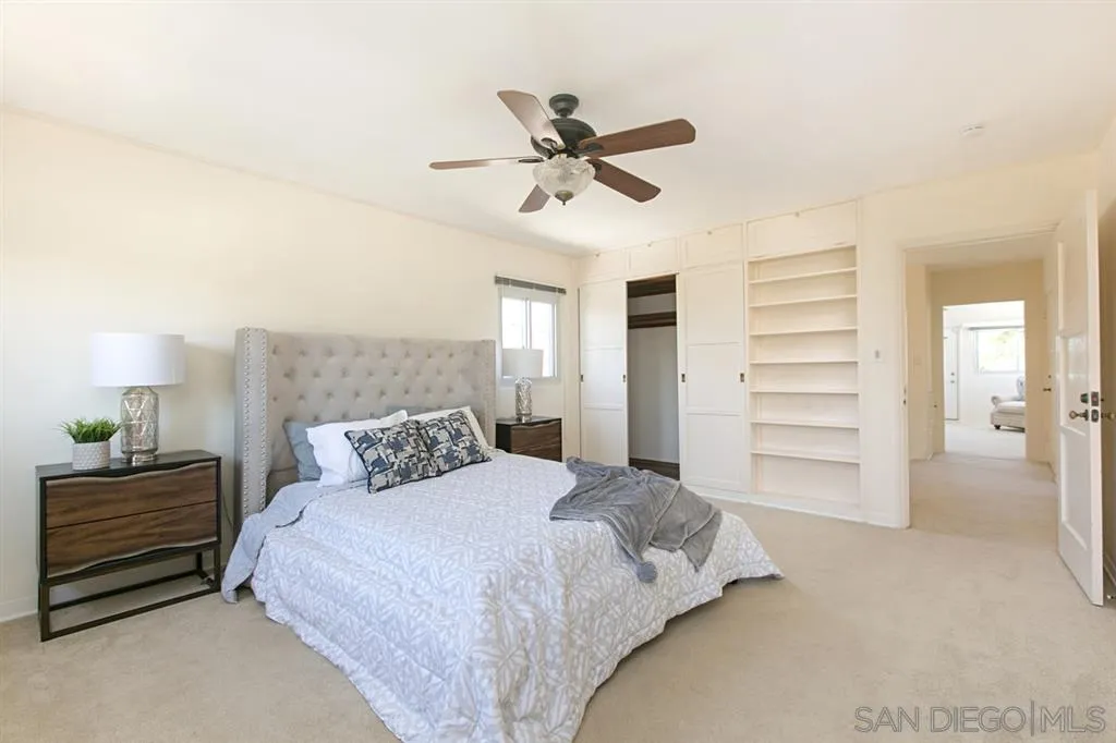 2355 Willow Street San Diego, CA 92106 - Photo 13 of 25 a bedroom with a bed and a ceiling fan
