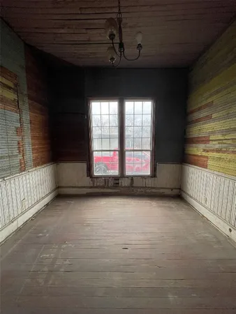 a view of an empty room with windows