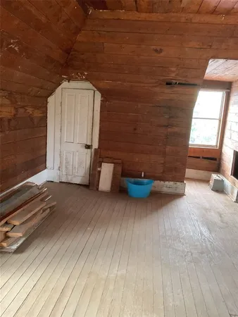 a view of an empty room and a window