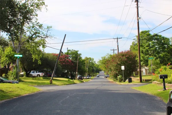 a view of a street with a building in the background