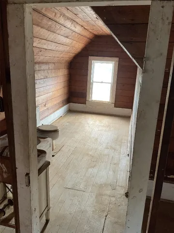 a view of an empty room and a window